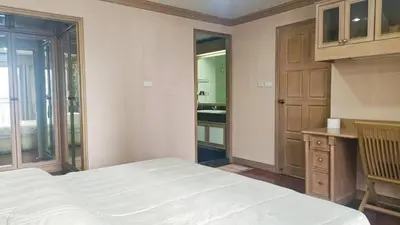 a bedroom with a bed and a bathroom with a sink at Smile Residence at Kaset-Sena in Ban Yang