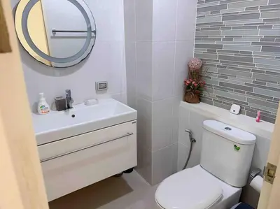a bathroom with a sink and a toilet and a mirror at HIGH RISE LUXURY CONDO 1BED ROOF TOP POOL 2 MinMRT in Bangkok
