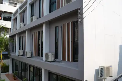 an external view of a building with windows at Varinda Hostel in Bangkok
