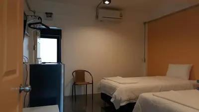 a hospital room with two beds and a window at Varinda Hostel in Bangkok