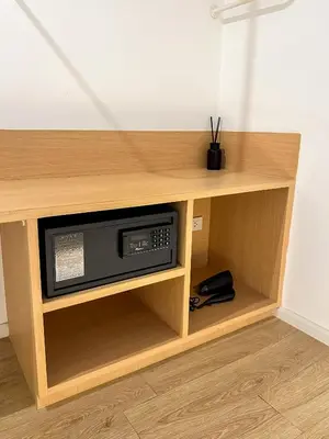 a wooden cabinet with a microwave inside of it at E11 Hotel - BTS Punnawithi in Amphoe Phra Khanong