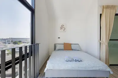 a small bedroom with a bed and a balcony at Advanced townhouses can accommodate 14 people, with high-speed Wi Fi and parking on Netflix in Ban Non Yang Ngam
