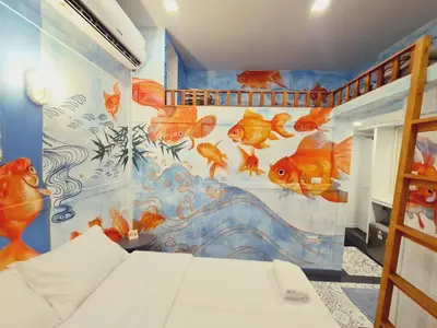 a bedroom with a fish mural on the wall at Suraya Bangkok in Bangkok