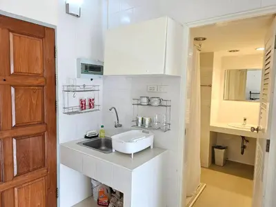 a kitchen with a sink and a counter top at Cozy 1br walk to BTS and Airport Rail Link Close to Malls m11 in Bangkok
