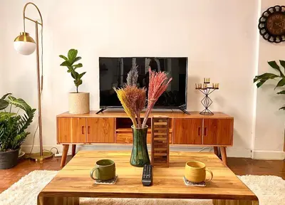 a living room with a tv and a coffee table at Flip Flop In Townhouse in Bangkok