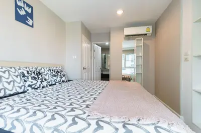 a bedroom with a large bed in a room at Internet celebrity train night market swimming pool free WiFi mrt 100m in Ban Tha Satu