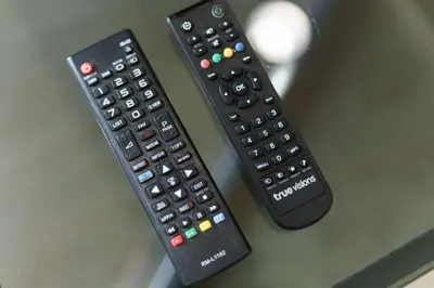two remote controls sitting on top of a table at Internet celebrity train night market swimming pool free WiFi mrt 100m in Ban Tha Satu