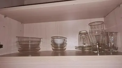 a row of glass vases sitting on a shelf at 1BR Thonglor , Fast WiFi , Near Samitivej , Nightlife in Khlong Toei