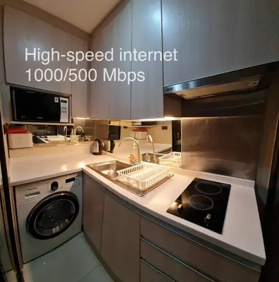 a kitchen with a sink and a stove top oven at 1BR Thonglor , Fast WiFi , Near Samitivej , Nightlife in Khlong Toei