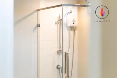 a bathroom with a shower with a glass door at MRT rame9 Jodd Fairs night market, walk for a few minutes, two bedrooms and two bathrooms in Ban Don Sai