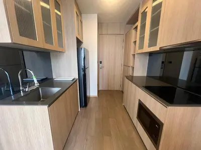 a kitchen with a sink and a refrigerator at 2 Bedroom Luxury Apartment 3 min walk from BTS Ekkamai in Bangkok