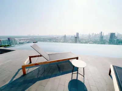 a bench sitting on the edge of a building at 2 Bedroom Luxury Apartment 3 min walk from BTS Ekkamai in Bangkok