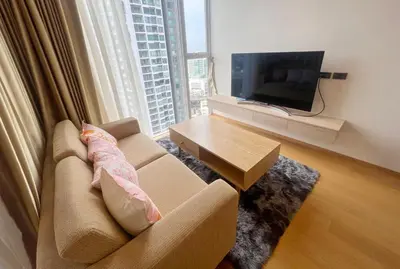 a living room with a couch and a television at 2 Bedroom Luxury Apartment 3 min walk from BTS Ekkamai in Bangkok
