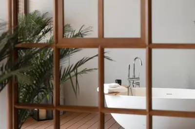 a bathroom with a sink and a mirror at Stay Plus Hotel Bangkok in Bangkok