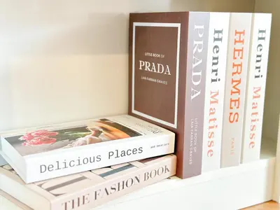 a stack of books sitting on a shelf at NK hostel in Thung Si Kan