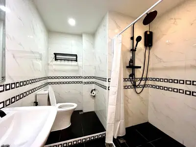 a bathroom with a sink and a toilet and a tub at DiscoveryHome2 at Pratunammarket in Bangkok