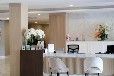 a salon with two chairs and a counter with flowers at Shewin de Bangkok in Ban Bang Bamru