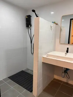 a bathroom with a sink and a phone on the wall at Dado9home in Khlong Toei