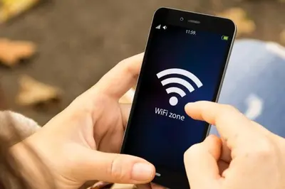 a person holding a cell phone with a wifi logo on it at 420 House- up to 10 guests in central Bangkok. in Bangkok
