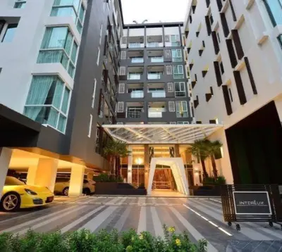 a building with a yellow car parked in front of it at interLux Premier Sukumvit , Nana , Bangkok in Bangkok