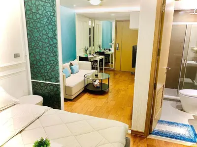 a room with a bed and a couch and a bathroom at interLux Premier Sukumvit , Nana , Bangkok in Bangkok