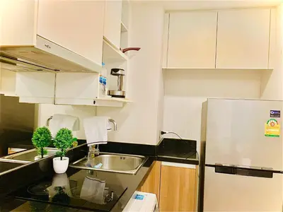a kitchen with a sink and a refrigerator at interLux Premier Sukumvit , Nana , Bangkok in Bangkok