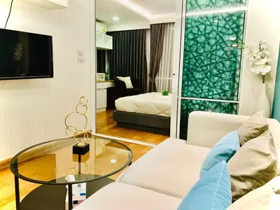 a living room with a couch and a glass table at interLux Premier Sukumvit , Nana , Bangkok in Bangkok