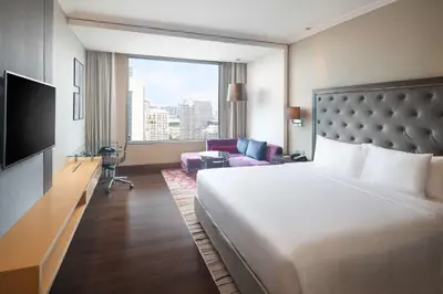 a hotel room with a bed and a large window at Radisson Blu Plaza Bangkok in Bangkok