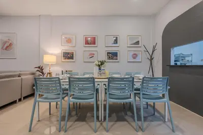 a dining room with a table and blue chairs at Spacious Haven Chatuchak Market 5BR 10 Sleeps RB1 in Ban Zong Katiam