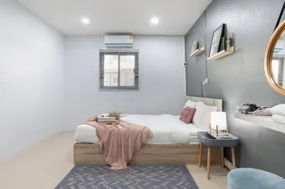 a small bedroom with a bed and a mirror at Spacious Haven Chatuchak Market 5BR 10 Sleeps RB1 in Ban Zong Katiam