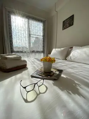 a pair of glasses sitting on top of a bed at 1 min walk to BTS, 3 Bed 3 Bath, Entire House in Bangkok