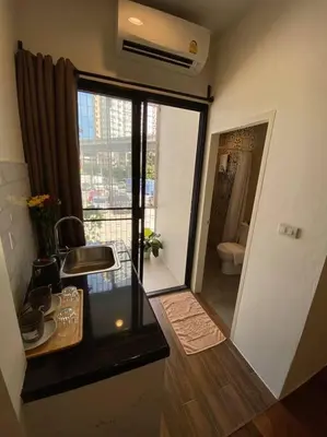 a room with a bathroom with a window and a toilet at 1 min walk to BTS, 3 Bed 3 Bath, Entire House in Bangkok