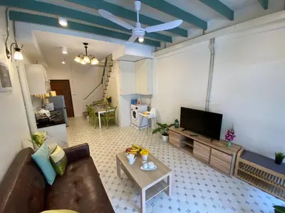 a living room with a couch and a flat screen tv at 1 min walk to BTS, 3 Bed 3 Bath, Entire House in Bangkok