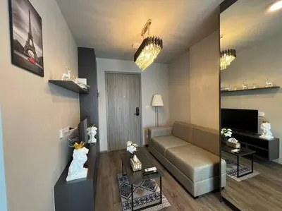 a living room with a couch and a table at Monte Rama 9 near JodFair Market Condo in Bangkok