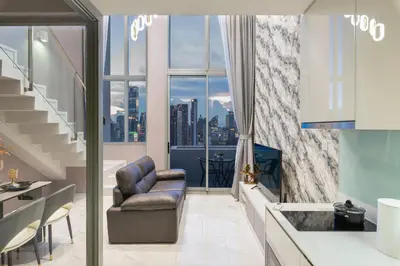 a living room with a view of a city at The Pinnacle Sukhumvit 11 by LeFoyer in Bangkok