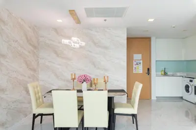 a dining room with a table and chairs at The Pinnacle Sukhumvit 11 by LeFoyer in Bangkok