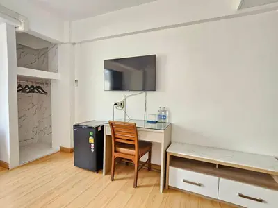 a room with a desk with a chair and a computer at Crown BTS Nana Hotel in Bangkok