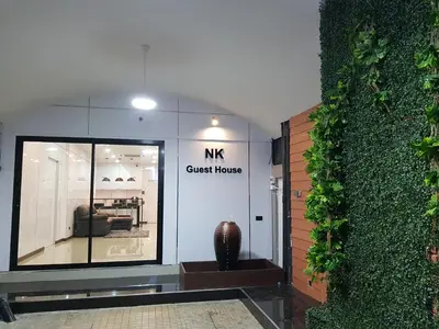 a guest house with a vase in a window at NK Guesthouse 1 in Khlong Toei