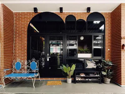 a black front door of a building with a blue bench at Double Studio, Private Bath, Shared Kitchen with Local Family by Pillows & Purrs in Bangkok