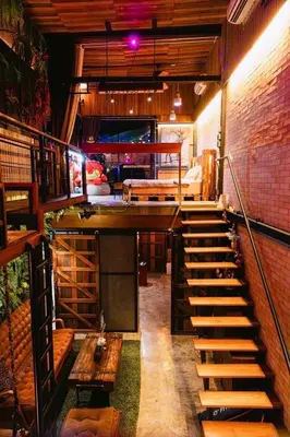 a room with stairs leading up to a room with a bed at New York Loft & Japanese Magic by V4SKIN in Bangkok