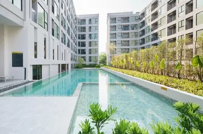 a swimming pool in the middle of a building at Sathon-Charoen Nakhon Condo in Bangkok