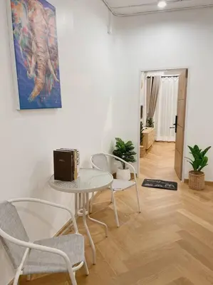 a living room with a table and chairs and a picture at Unwind in oldtown, private floor, near Grand Palace in Bangkok