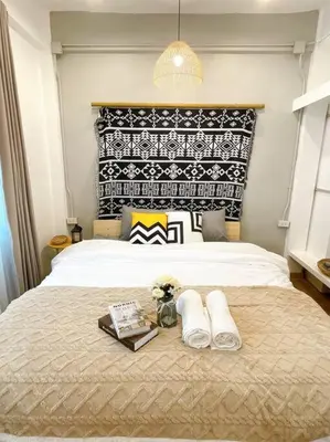 a bedroom with a bed with two towels on it at Unwind in oldtown, private floor, near Grand Palace in Bangkok