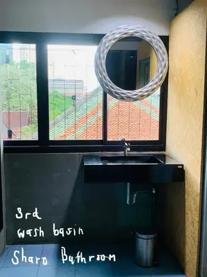 a bathroom with a sink and a mirror at Enterspace Chinatown in Khlong San