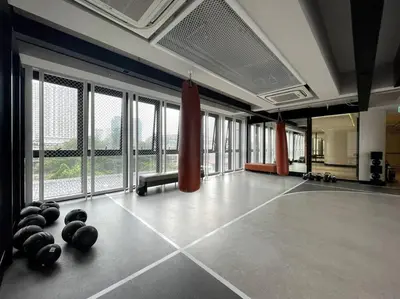 a gym with balls on the floor in a room with windows at Luxury River View in Bangkok