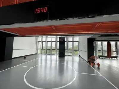 an empty basketball court in a building with a clock at Luxury River View in Bangkok