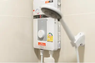 a white soap dispenser on a wall in a bathroom at \u6c99\u541eSathon-Charoen Nakhon\u7cbe\u54c1\u516c\u5bd3 in Bangkok