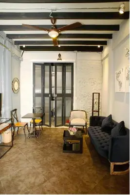 a living room with a couch and a ceiling fan at Inner Old Town 196 Chic Guesthouse - self check in in Bangkok