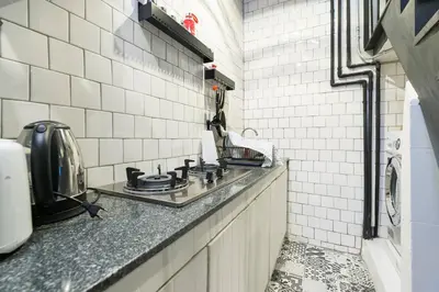 a kitchen with a counter top with a stove at Inner Old Town 196 Chic Guesthouse - self check in in Bangkok