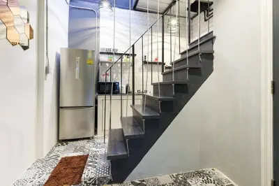 a hallway with a staircase with a stainless steel refrigerator at Inner Old Town 196 Chic Guesthouse - self check in in Bangkok